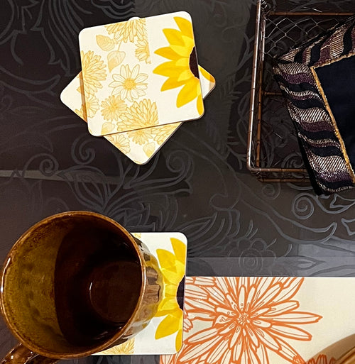 A picture of sunflower coasters with a mug on top